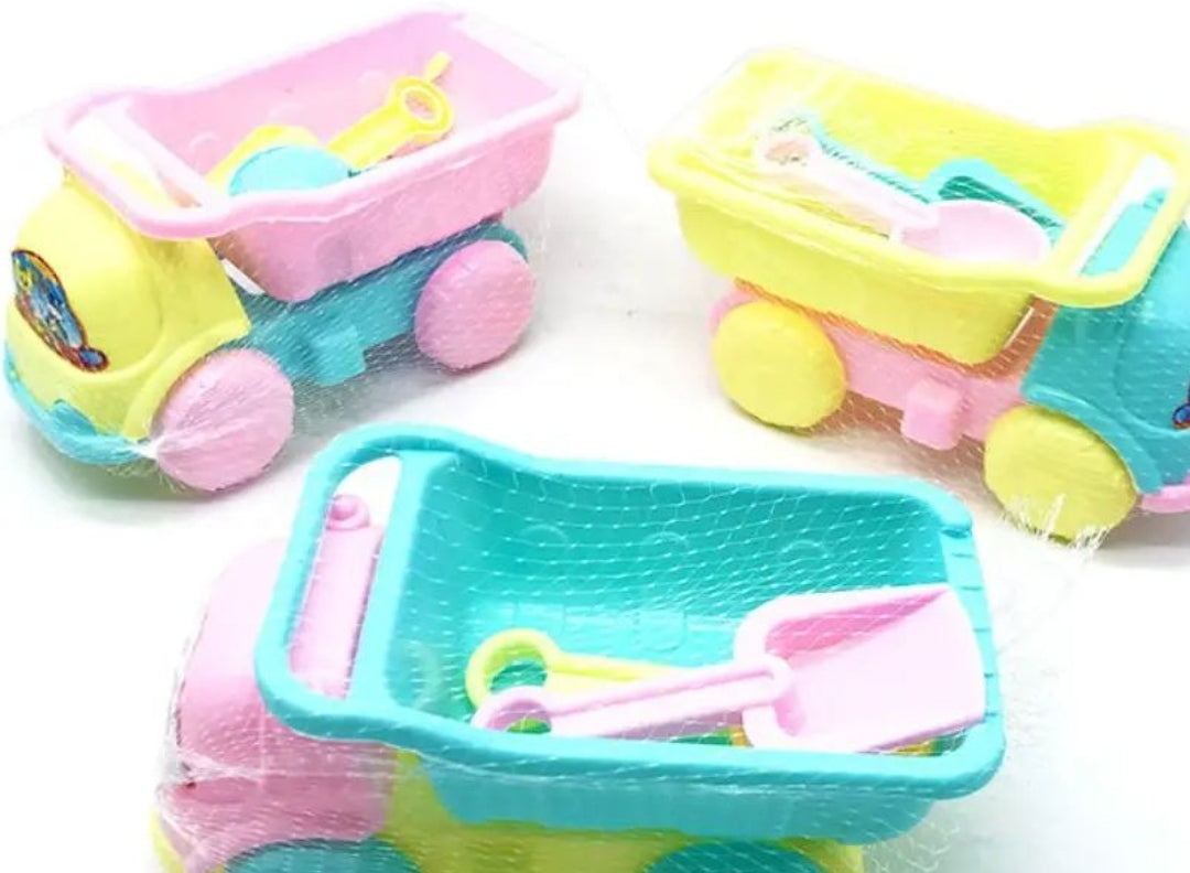 Colorful toy sand trucks with sand toys on a white background