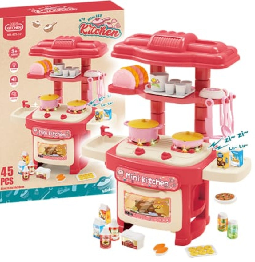 Toy kitchen set with pink stove and accessories, including a matching box.